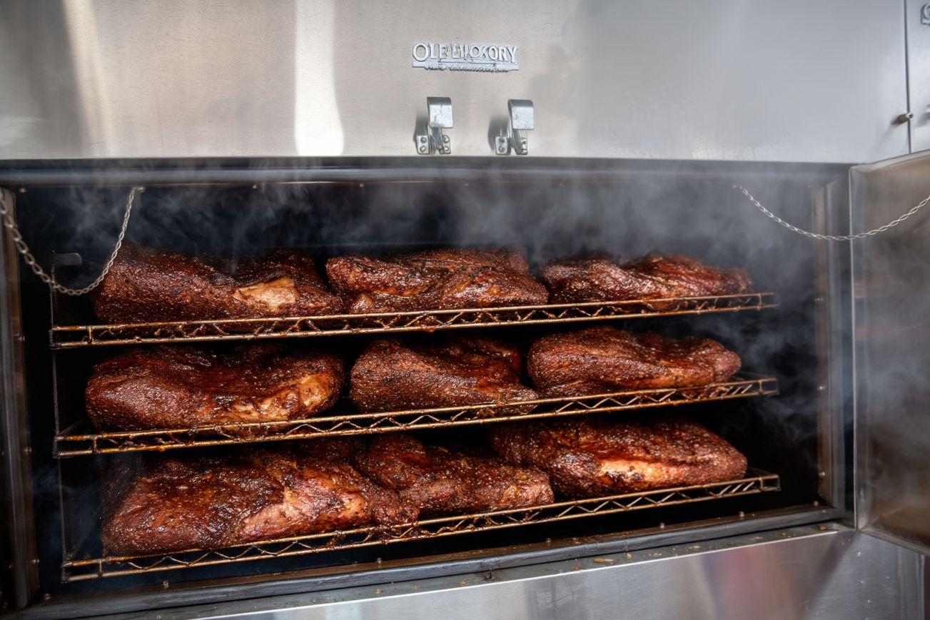Briskets stacked on the Ole Hickory smoker racks