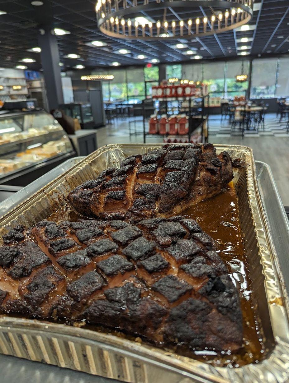 Smoked pork butts resting in foil pans